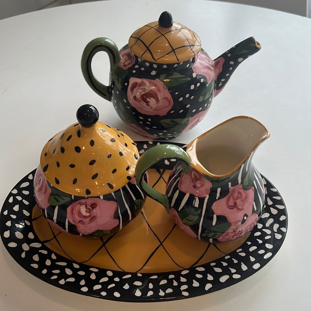 droll design tea pot and creamer sugar on plate